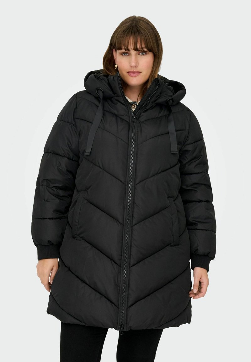 Black puffer coat with a hood, featuring a quilted chevron pattern, front zipper, and elastic cuffs. Soft, thick material for warmth.