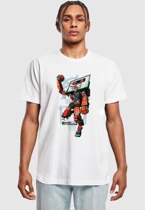 White cotton t-shirt featuring a graphic of a robot playing basketball, with vibrant red, blue, and black colors, and text below "Shootin' like a Machine."