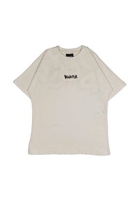 T-shirt oversize beige in cotone, con colletto rotondo, maniche corte e la scritta "Disclaimer" stampata in nero sulla parte anteriore.