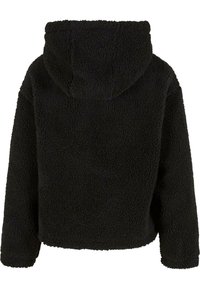 Svart fleecejacka med huva och mjuk, strukturerad yta. Kort längd och lös passform, med sänkta axlar och elastiska muddar.