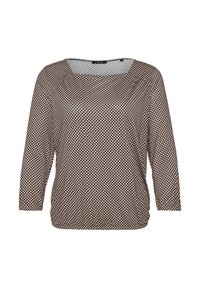 Blouse beige à manches longues avec un motif de points noirs irréguliers et un col carré, présentée sur fond blanc.