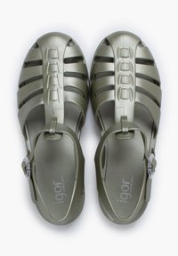 Green plastic sandals with cut-out design, closed toe, adjustable strap, and textured sole. Features logo on the side.