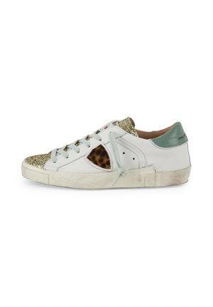 White low-top sneaker with gold glitter toe, leopard print side patch, light blue laces, and green heel tab on a worn sole.