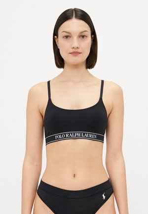 Melna bralette ar plānām siksniņām, ar baltu "POLO RALPH LAUREN" joslu. Matēta tekstūra un vienkāršs, pieguļošs dizains.