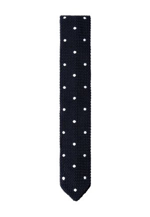 Corbata negra de punto con lunares blancos, ancho estrecho y punta puntiaguda sobre fondo blanco.