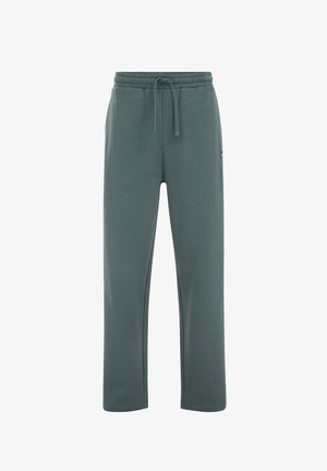 Tamnotegetalne trenirke od meke mješavine pamuka, s elastičnim pojasom i vezicama, bočnim džepovima i opuštenim krojem.