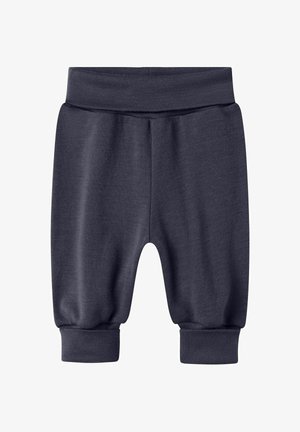 Pantalons de survêtement gris foncé en tissu doux, avec une taille élastique et des poignets élastiques aux chevilles, avec une coupe décontractée.