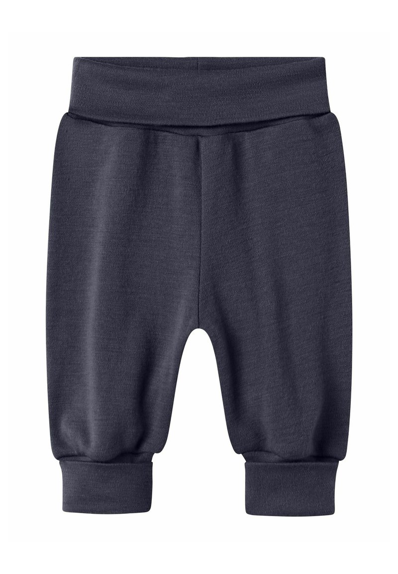 Mörkgrå sweatpants tillverkade av mjuk material, med elastisk midja och elastiska manschetter vid anklarna, i avslappnad passform.