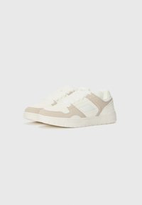 White and beige sneakers with a suede and textile upper, round toe, flat laces, padded collar, and rubber outsole with traction patterns.