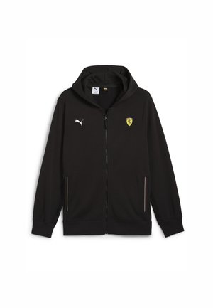 Black zip-up hoodie made of soft fabric, featuring a hood, Puma logo, Ferrari emblem, and side pockets with contrasting zippers.