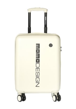 Valise rigide couleur crème avec logo "momoDESIGN" vertical, poignée télescopique et quatre roulettes pivotantes.