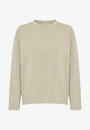 Sweatshirt long à manches longues beige clair avec un col rond, coupe décontractée et texture lisse. Détails en coutures à l'ourlet et aux poignets.