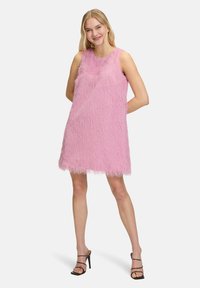 Robe sans manches rose en matériau texturé et duveteux, présentant une silhouette droite et un ourlet qui se termine au-dessus du genou.