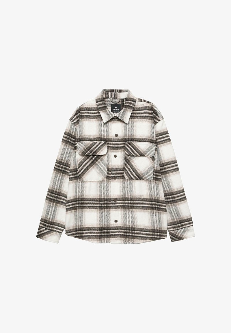 Koszula flanelowa w kratę w odcieniach bieli, czerni i szarości. Posiada dwie kieszenie na piersi i zapięcie na guziki z przodu. Miękka tekstura i luźny krój.