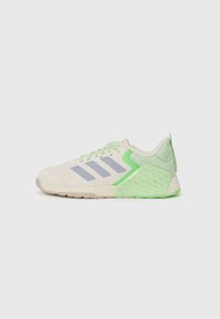 Sneakers with a light cream mesh upper, mint green accents, gray three-stripe logo, and a textured green rubber sole for grip.