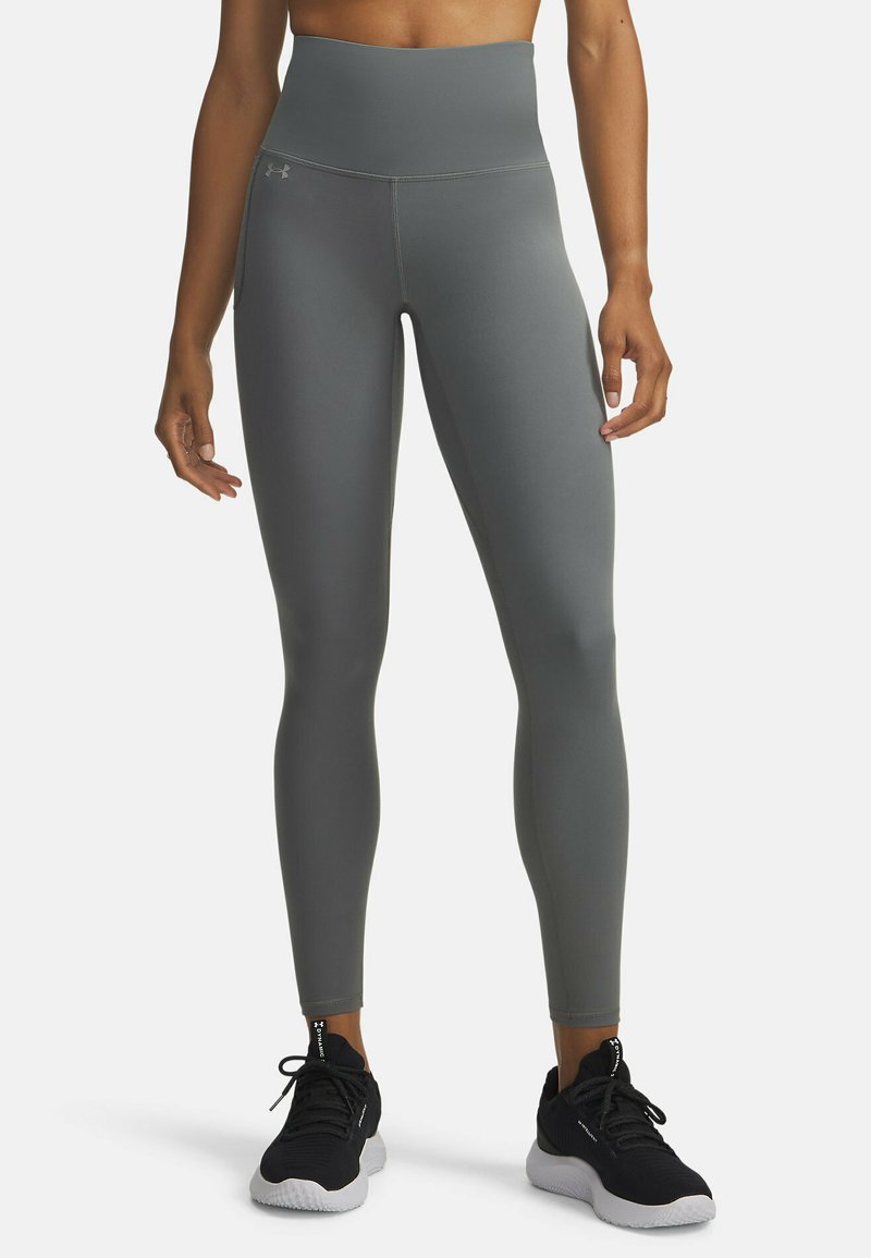 Leggings de sport taille haute et ajustés, en tissu gris mat lisse. Caractérisés par des coutures plates pour le confort et un design minimaliste.