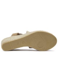 Slip-on shoe featuring a beige suede upper, textured cork midsole, and a rubber outsole with a ribbed pattern. Size 38, made in Spain.