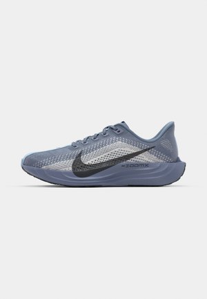 Fűzős sportcipő, légáteresztő hálós felsőrészben, világoskék és szürke árnyalatokban, fekete Nike Swoosh-szal és strukturált talppal.
