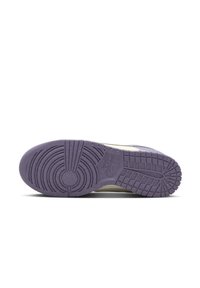 Shoe outsole in purple rubber with circular and grid patterns, featuring a textured surface and a logo. Designed for traction and durability.