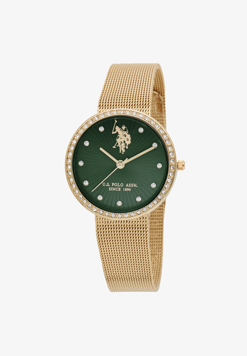 Orologio in rete dorata con quadrante verde, dettagli in cristallo e un'emblema di un giocatore di polo al centro. Presenta lancette delle ore e dei minuti dorate.
