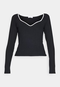 Zwarte geribbelde top met lange mouwen en een aangesloten ontwerp, met een witte contrastrand langs de V-halslijn. Glad textuur en reguliere snit.