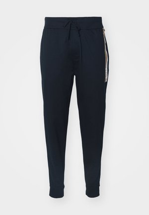 Pantalons de jogging navy en tissu doux avec taille à cordon de serrage, bas fuselés et rayure latérale avec détails de logo.