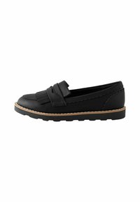 Sort læder loafer med franje detaljer, bølget kant og en kontrasterende tan sål med tekstureret overflade.
