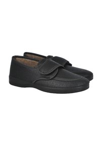 Zapatos negros hechos de material texturizado con una correa de velcro, punta redondeada y interior acolchado. Suela ligera para mayor comodidad.