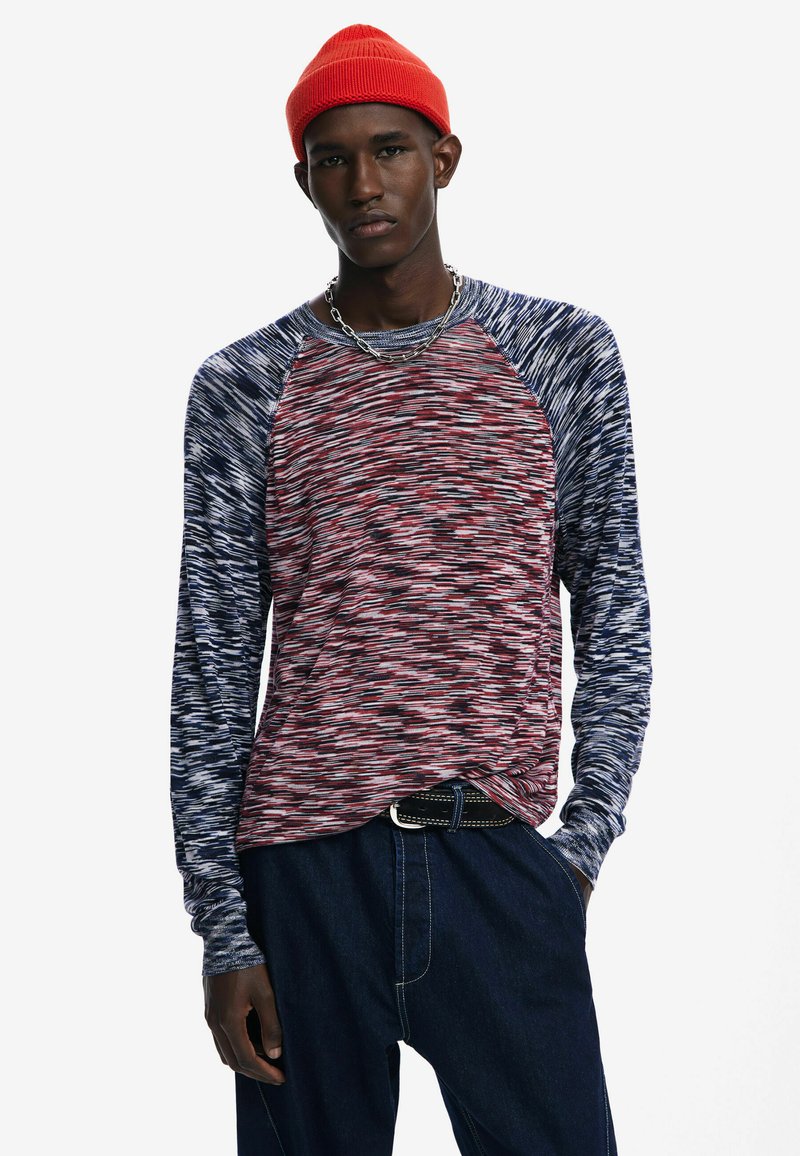 Pikad varrukad, ümar kaelusega särk, millel on punane ja tumesinine marli muster, kontrastsete raglan varrukatega ja mugav lõige.