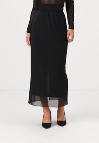 Juodas maksi sijonas pagamintas iš lengvos medžiagos, pasižymintis lygiu juosmeniu ir vidutinio ilgio permatoma uždanga su centru plyšiu judėjimui.