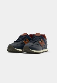 Navy leather sneakers with maroon accents, a brown logo, and gray laces. Features a textured sole for traction and cushioned collar.