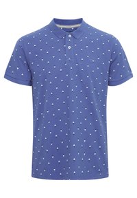 Blått polo skjorte laget av bomull, med et mønster av små hvite trekanter. Inkluderer klassisk krage og tre-knappers placket.