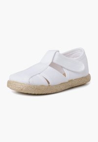 White canvas shoe with elastic straps and cutouts, featuring a natural jute sole. Lightweight and flexible design for comfort.
