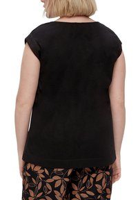 Black short-sleeve top with a rounded neckline, made of soft fabric. Simple design with no visible patterns or accents.