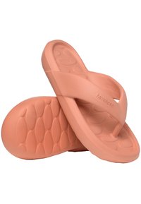 Pink rubber flip-flops with a textured sole featuring oval patterns and a smooth strap design. Lightweight and flexible.
