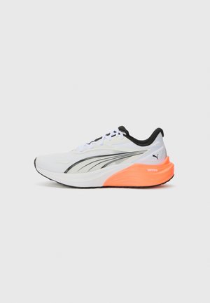 White athletic shoe with black accents, mesh upper, and orange sole. Features a sleek shape and flat lacing system for secure fit.