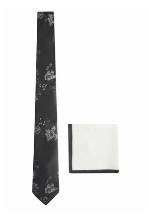 Black tie with floral pattern in gray and blue, paired with a white pocket square featuring a black border.