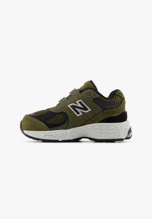 Olive green athletic shoe with black accents, suede and mesh materials, chunky white midsole, textured rubber outsole, adjustable straps.
