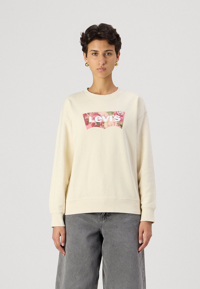 Krémová mikina s dlhým rukávom a uvoľneným strihom, s grafickým logom Levi's vo florálnom dizajne na prednej strane. Textúrovaná látka.