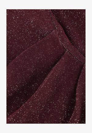 Burgundy fabric with a textured surface, featuring scattered metallic silver threads for a shimmering effect, structured in pleats.