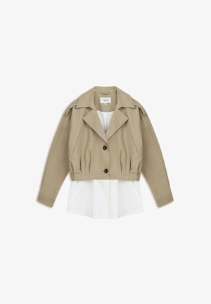Beige Jacke mit gekürzter Länge, Knopfverschluss, schräge Taschen und einer weißen Innenschicht. Mit klassischem Kragen und strukturierten Schultern.