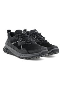 Black athletic shoes featuring a mix of smooth and textured materials, with a cushioned sole, rubber outsole, and reflective accents.
