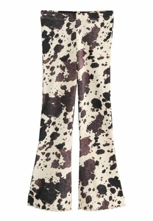 Pantalons évasés côtelés en crème avec des motifs tachetés noirs et marron. Dotés d'une taille ajustée et de détails en ourlet festonné.