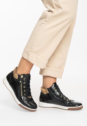 Black patent leather high-top sneakers with gold accents, featuring a side zipper, textured collar, and white rubber sole.