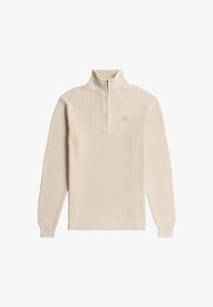 Jersey de medio cierre en color beige claro con textura acanalada, mangas largas raglán y un pequeño parche con logo en el pecho. Tejido de punto a máquina.