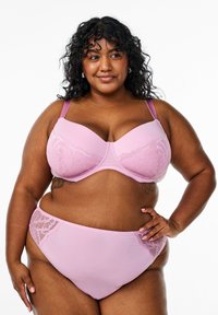 Light pink lace-trimmed bra with molded cups and adjustable straps, paired with matching high-waisted underwear featuring lace accents.