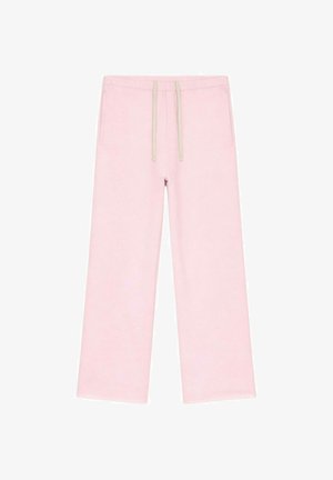 Pantalon de jogging large rose clair avec cordon de serrage beige et poches latérales, présenté sur un fond blanc.