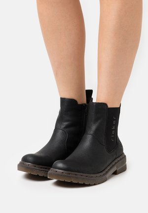 Schwarze Knöchelstiefel aus strukturierter Leder mit einem Seitenreißverschluss und elastischem Einsatz. Robuste Gummisohle mit leichtem Profil. Mit Logo-Akzent.
