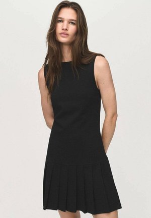 Black sleeveless A-line dress with a fitted bodice and pleated skirt. Made of smooth fabric, featuring a simple, elegant design.