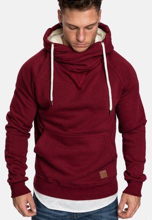 Burgundy hoodie made from soft fabric. Features a large, draped neck, drawstrings, front pocket, and ribbed cuffs and hem.